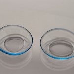 Contact lenses with drops of liquid inside lie on the table