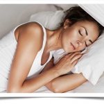 Young woman sleeps with her hand under the pillow